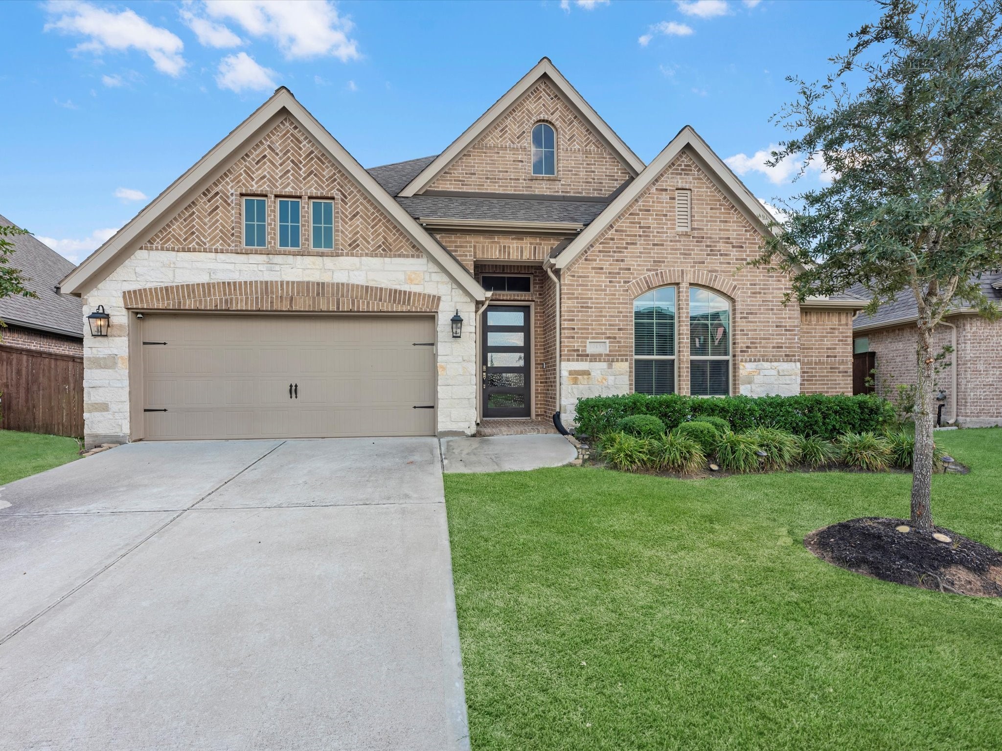 10135 Napier Drive Rosharon, TX 77583 - Photo 2 of 36 This stunning Perry Home was built in 2021, showcasing timeless curb appeal and elegant architectural details.
The covered front entry with upgraded brick and stone elevation creates a warm first impression.