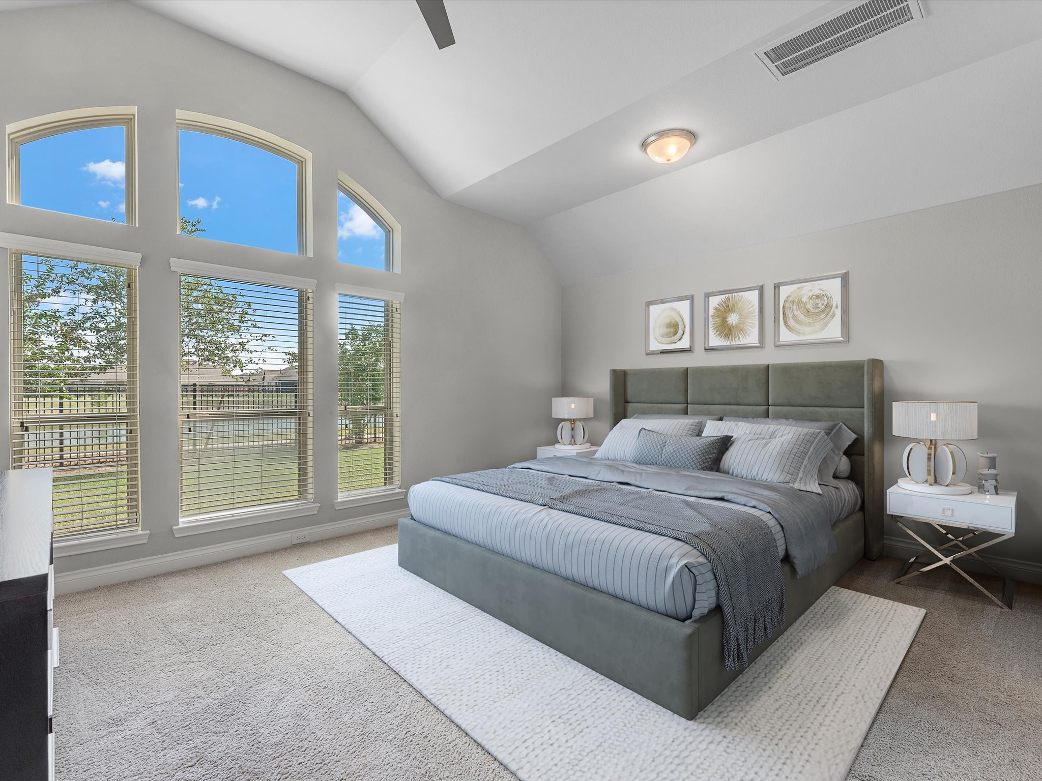 10135 Napier Drive Rosharon, TX 77583 - Photo 10 of 36 The spacious primary bedroom features high ceilings and ample space for a king-size bed. Enjoy peaceful views of the backyard and water from the comfort of your private retreat. *some elements are virtually staged*