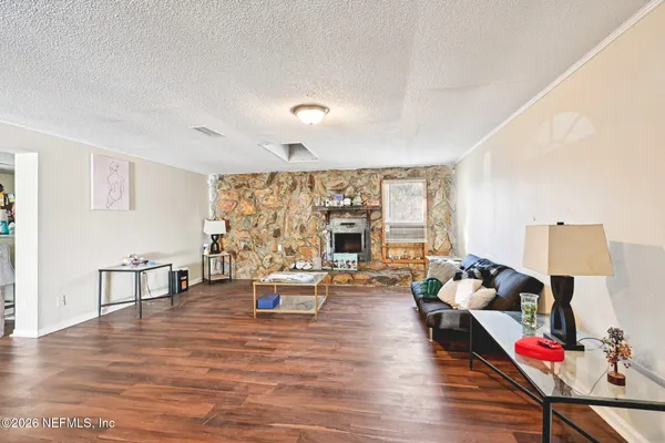 a living room with furniture and wooden floor