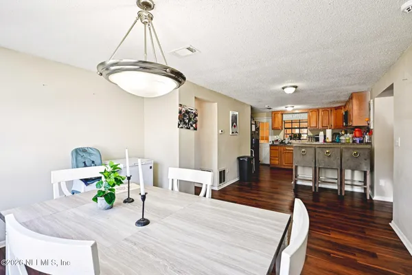 a dining room with furniture and wooden floor
