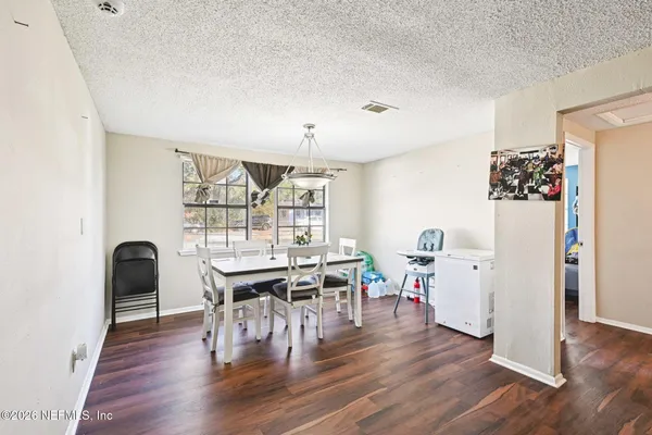 a view of a dining room with furniture and wooden floor