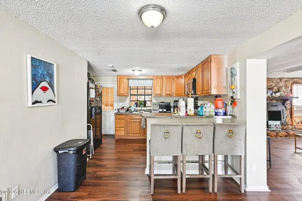 a kitchen with stainless steel appliances granite countertop a refrigerator and microwave