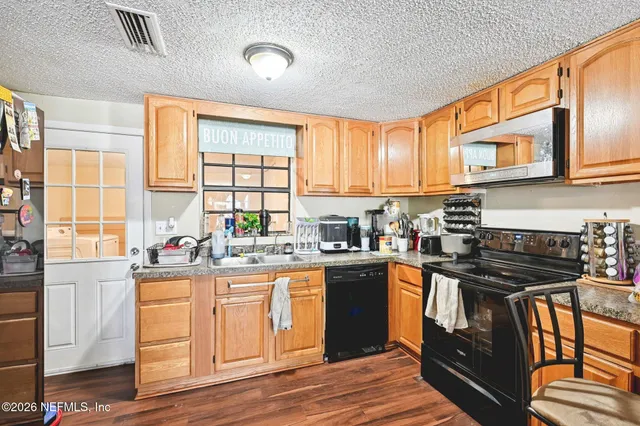a kitchen with stainless steel appliances granite countertop a stove and a sink