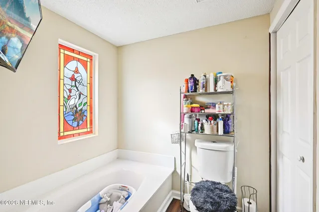 a bedroom with a bed and a book shelf