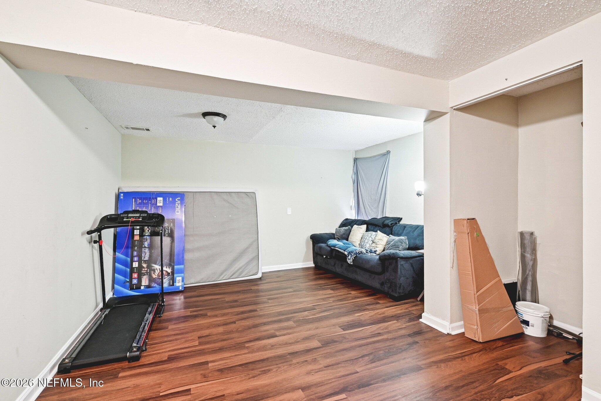2914 Carleon Road Jacksonville, FL 32218 - Photo 32 of 39 a living room with furniture and a wooden floor