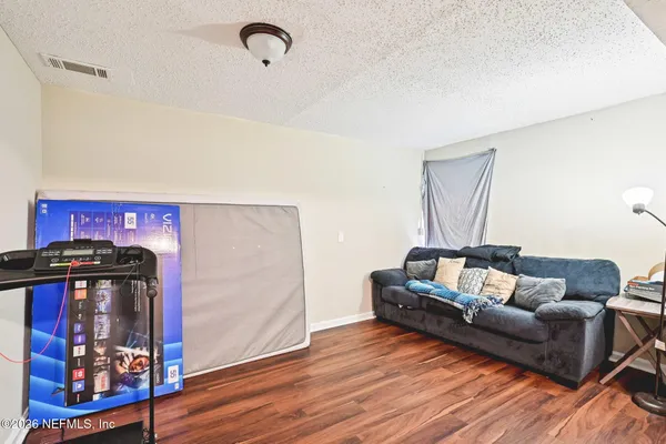 a living room with furniture and wooden floor
