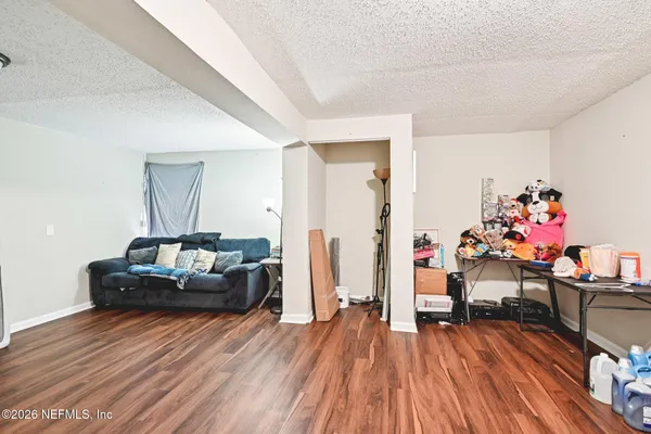 a living room with furniture and a wooden floor