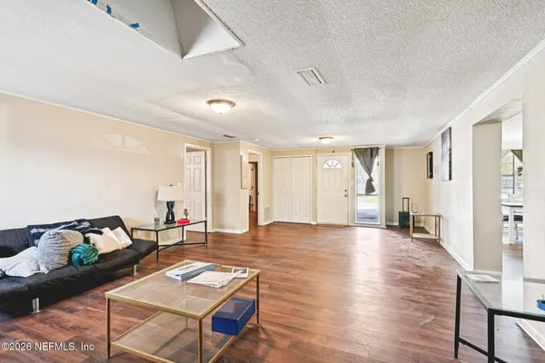 a living room with furniture and wooden floor