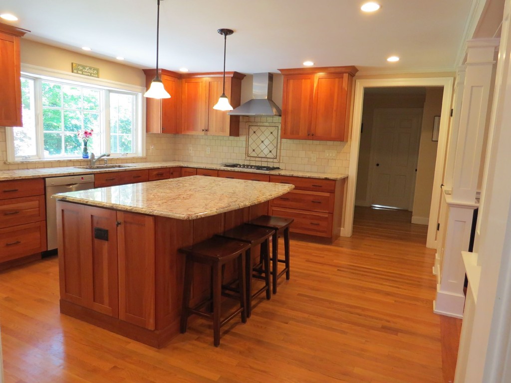 30 Aberdeen Road Weston, MA 02493 - Photo 4 of 24 a kitchen with stainless steel appliances granite countertop wooden floors wooden cabinets a window and a sink