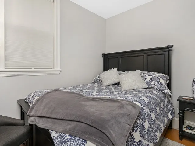 a bed sitting in a bedroom next to a window