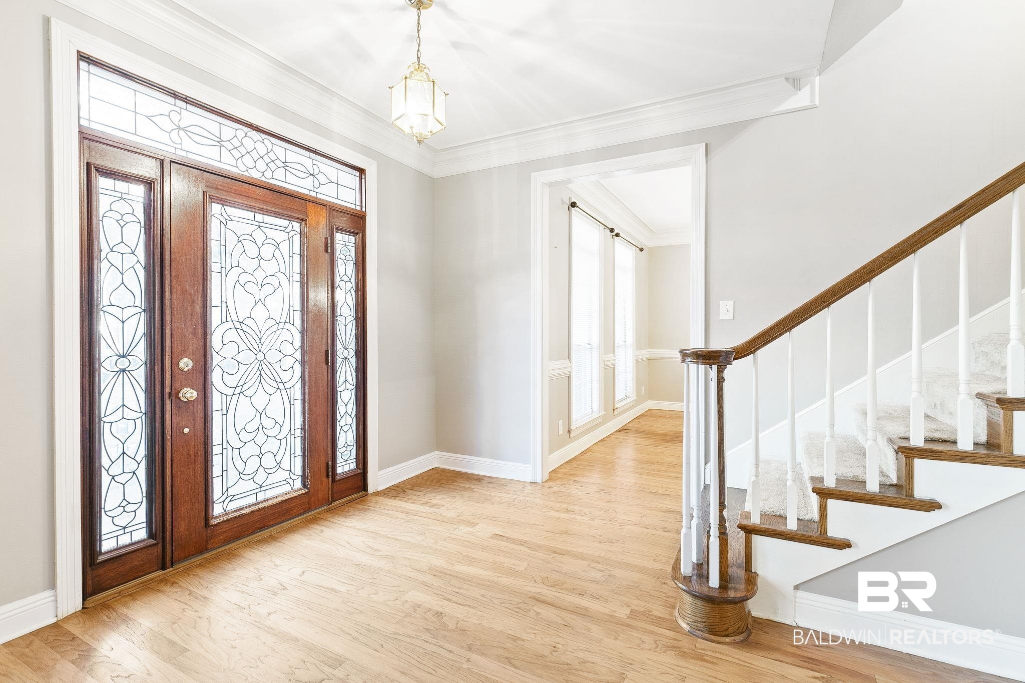 2100 Stonebrook Drive West Mobile, AL 36695 - Photo 9 of 60 Foyer entrance with light hardwood / wood-style flooring, a wealth of natural light, ornamental molding, and a notable chandelier