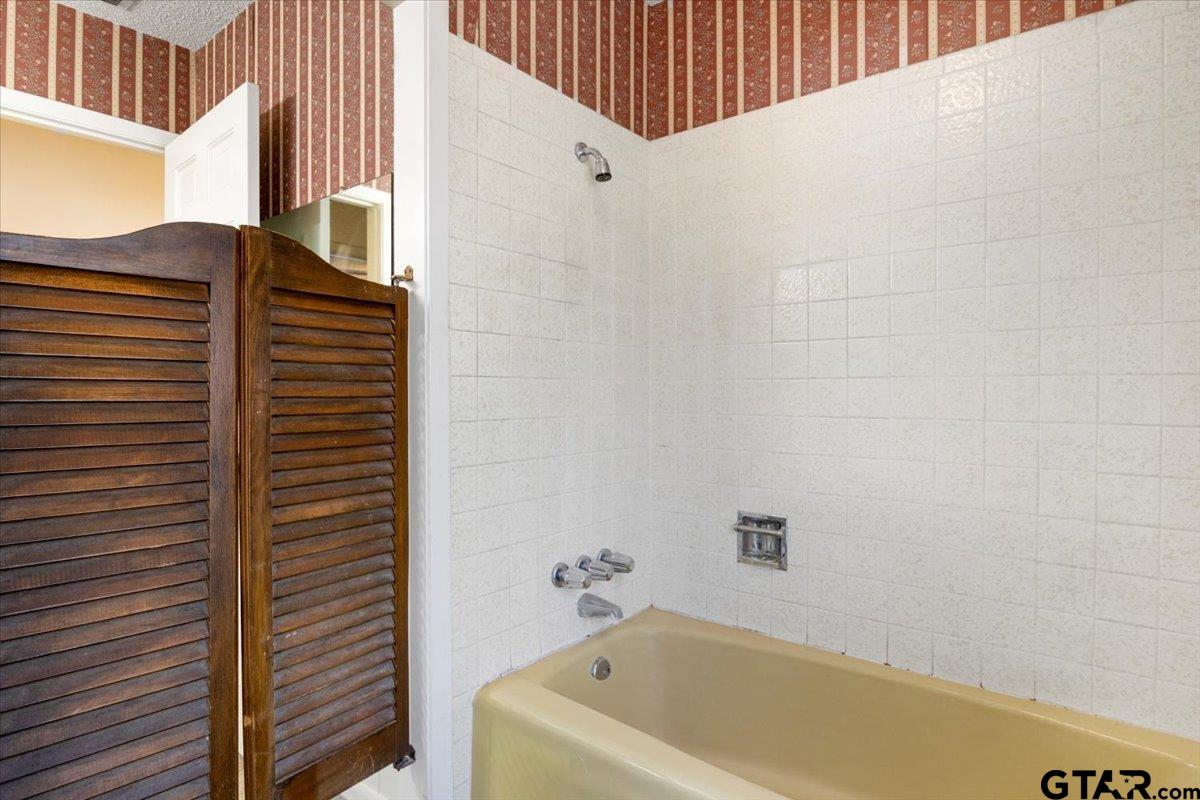 1302 Jeb Stuart Drive Tyler, TX 75703 - Photo 33 of 47 a bathroom with a bathtub and shower