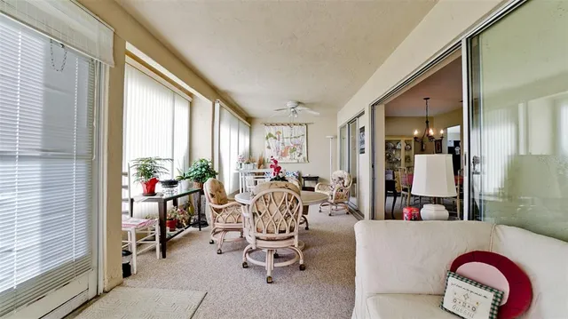 a view of a dining room with furniture and chandelier