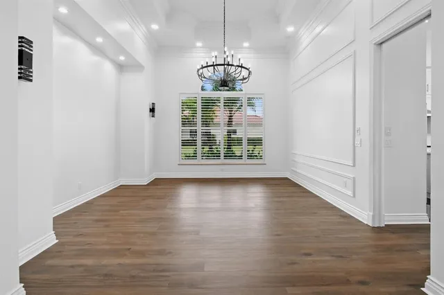 a bathroom with a double vanity sink a mirror a window and a bathtub