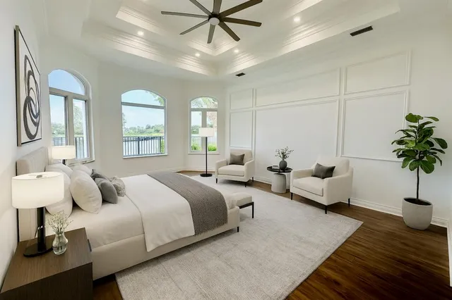 an empty room with wooden floor cabinet and windows