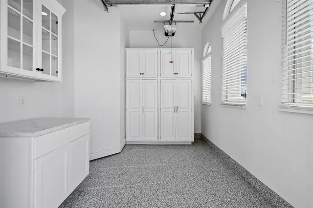 an aerial view of a city with lots of residential buildings and mountain view in back