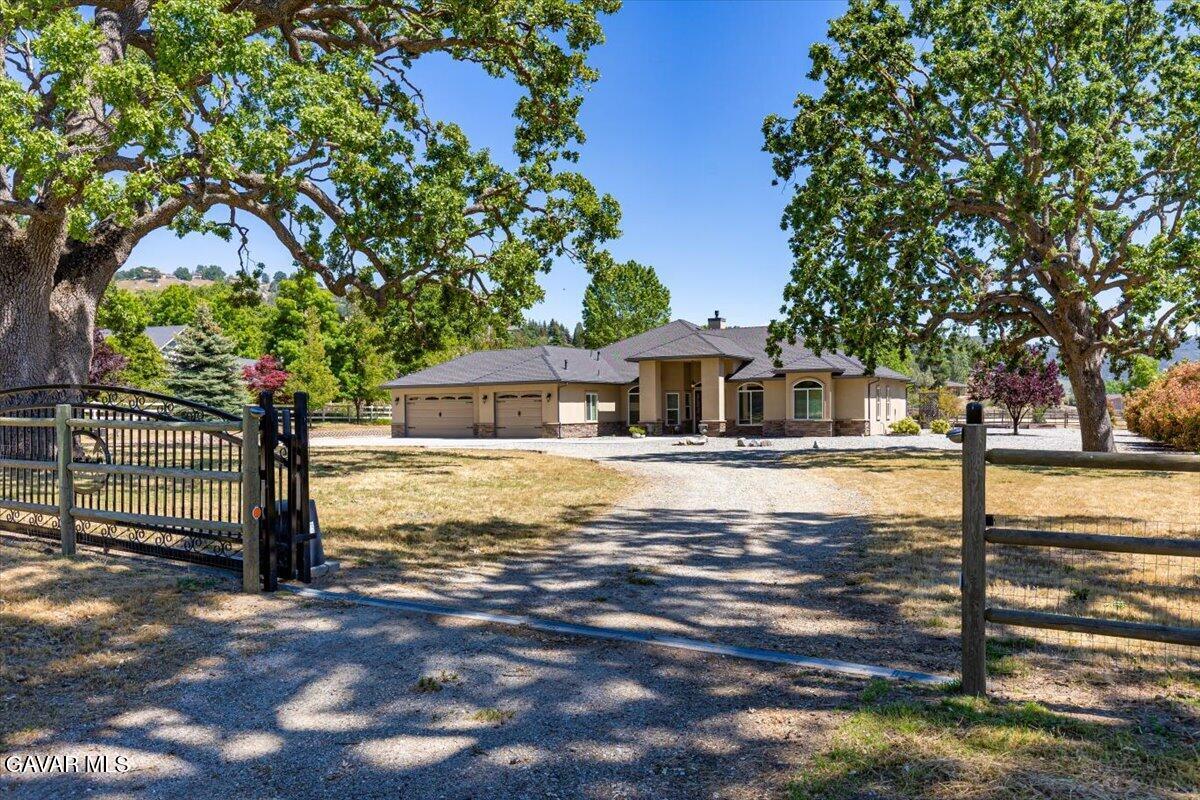 23840 Martingale Way Tehachapi, CA 93561 - Photo 62 of 63 a front view of a house with garden