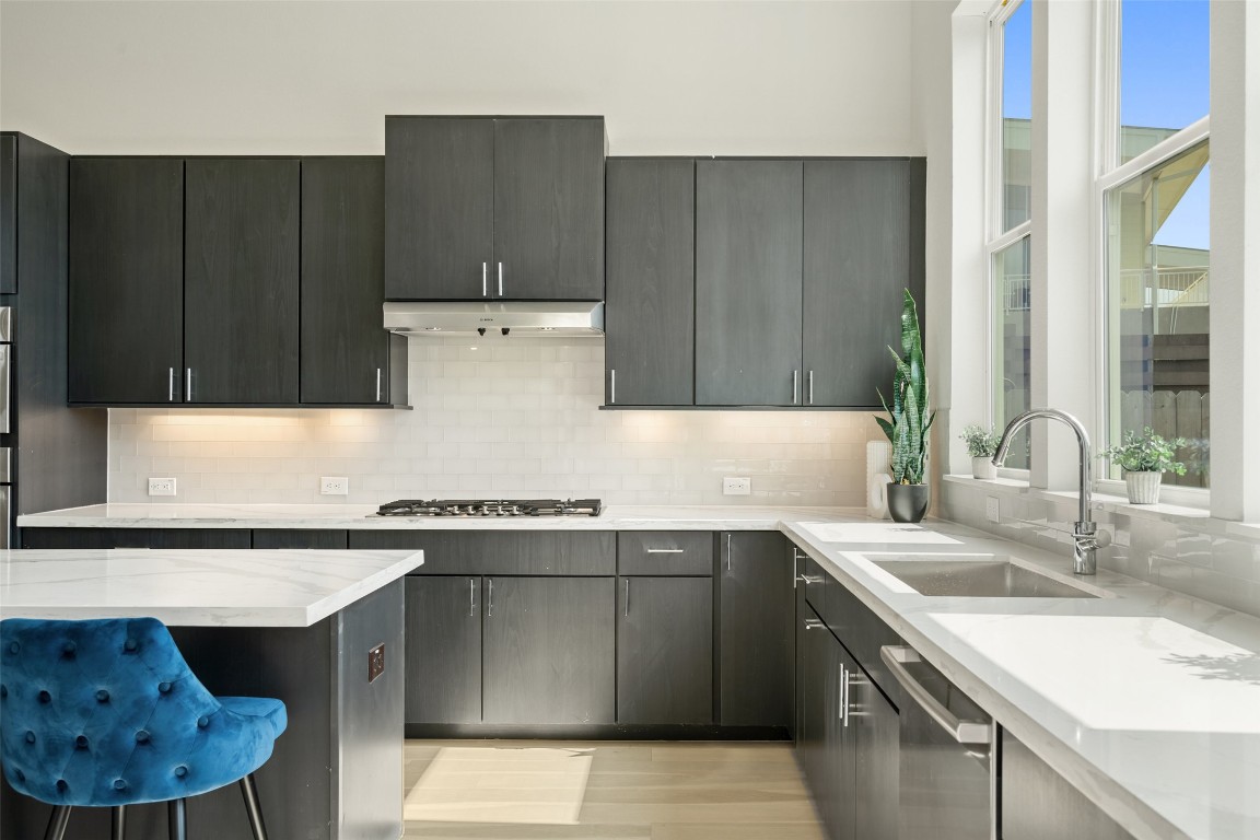 5500 Sendero Hills Parkway Austin, TX 78724 - Photo 12 of 23 a kitchen with a sink a stove and cabinets