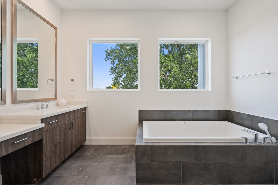 5500 Sendero Hills Parkway Austin, TX 78724 - Photo 19 of 23 a bathroom with a bathtub and window