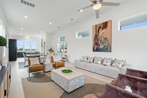 a living room with furniture kitchen view and a table