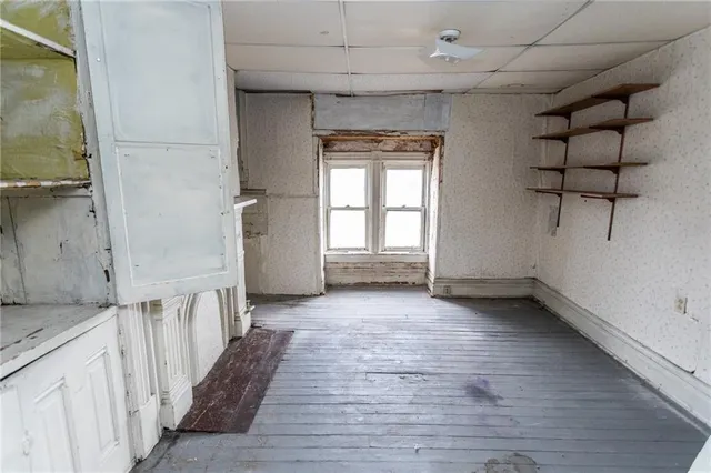 a view of a hallway with wooden floor and entryway