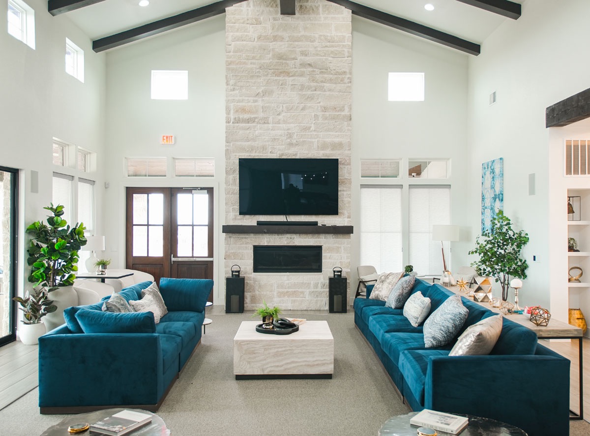 108-2 Rivalto Circle, Unit C3 Lakeway, TX 78734 - Photo 16 of 35 a living room with furniture a fireplace and a potted plant