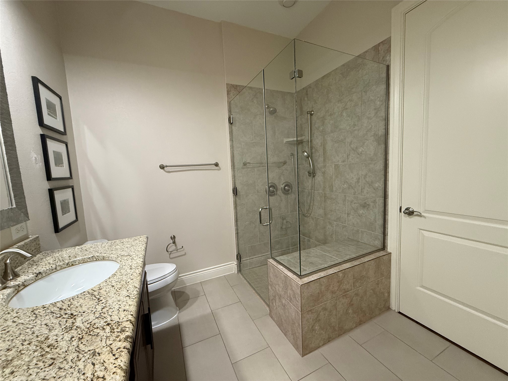 108-2 Rivalto Circle, Unit C3 Lakeway, TX 78734 - Photo 3 of 35 a bathroom with a granite countertop sink a toilet and shower