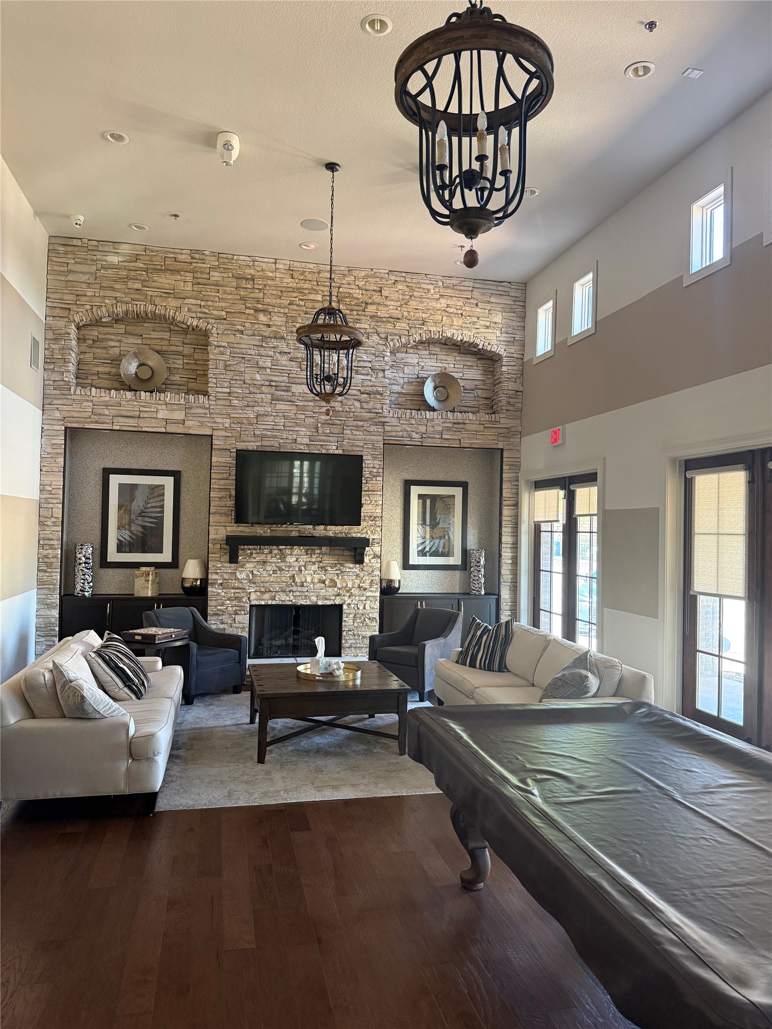 108-2 Rivalto Circle, Unit C3 Lakeway, TX 78734 - Photo 32 of 35 a living room with furniture a fireplace and a chandelier