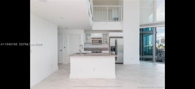 888 Biscayne Boulevard, Unit 906 Miami, FL 33132 - Photo 14 of 19 a kitchen with stainless steel appliances a refrigerator and a stove