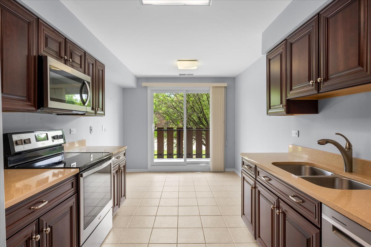 1795 Lake Cook Road, Unit 107 Highland Park, IL 60035 - Photo 10 of 26 a kitchen with a sink stove top oven and cabinets