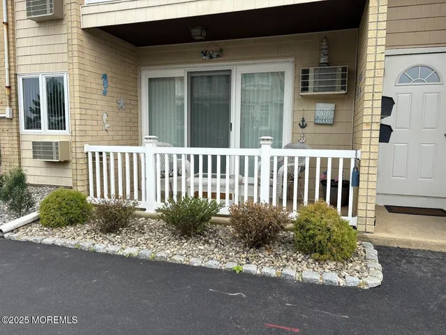 a view of a house with a small yard and wooden fence