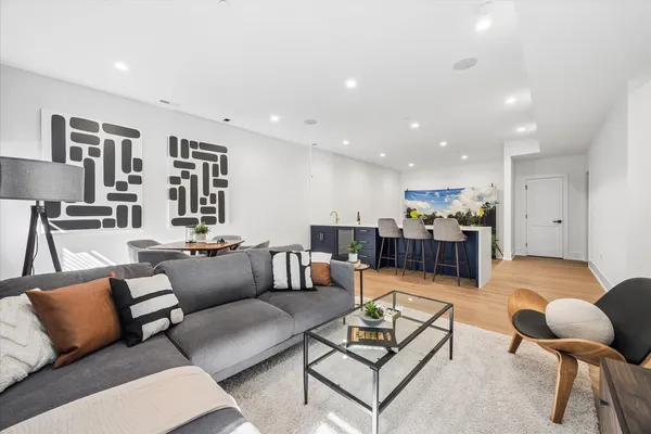 a living room with furniture and kitchen view