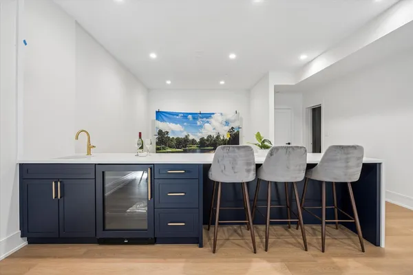 a kitchen with a sink cabinets and wooden floor