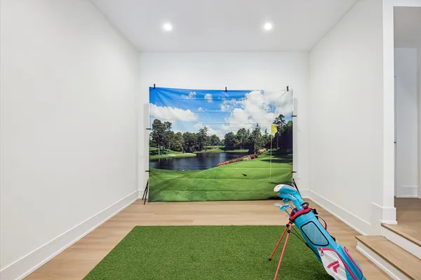 a room with green walls hardwood floor and a ceiling fan