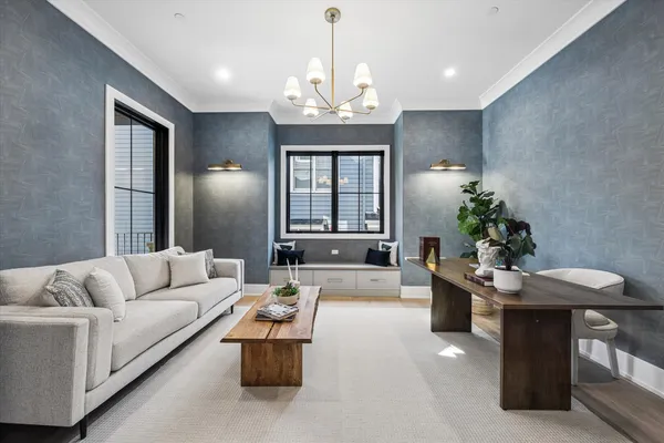 a living room with furniture and a chandelier