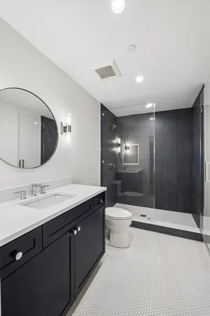 a bathroom with a double vanity sink and a mirror