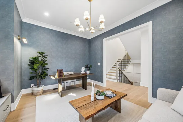a living room with furniture and a chandelier