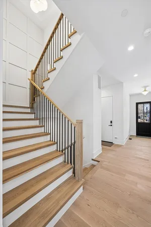 a view of an entryway with wooden floor