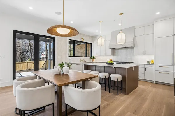 a kitchen with a table chairs stove and microwave