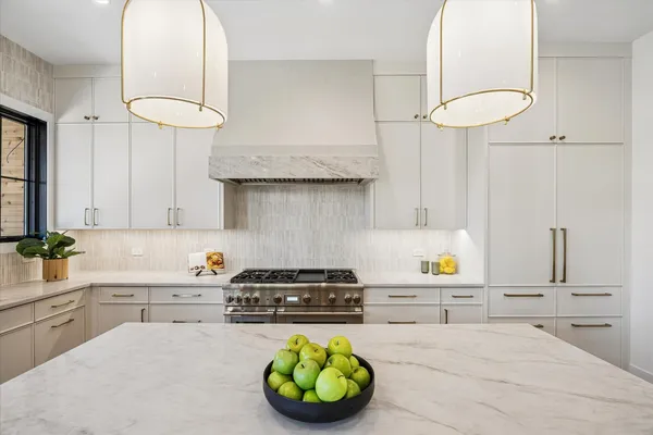 a kitchen with stainless steel appliances a sink a stove and a wooden floors