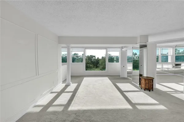 a living room with a bath tub and a glass door shower
