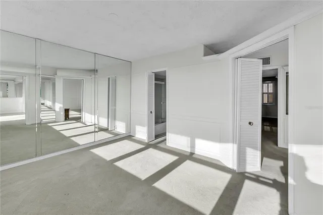 a view of a livingroom with an empty space and a ceiling fan
