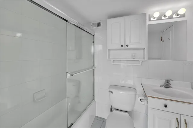a view of hallway with closet and wooden floor