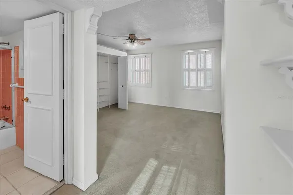 a view of hallway with closet and wooden floor