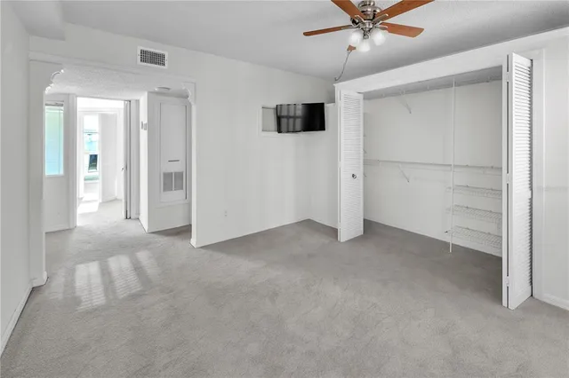 a workspace with a bookshelf and a large window