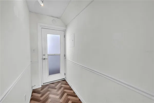 a workspace with a bookshelf and a large window