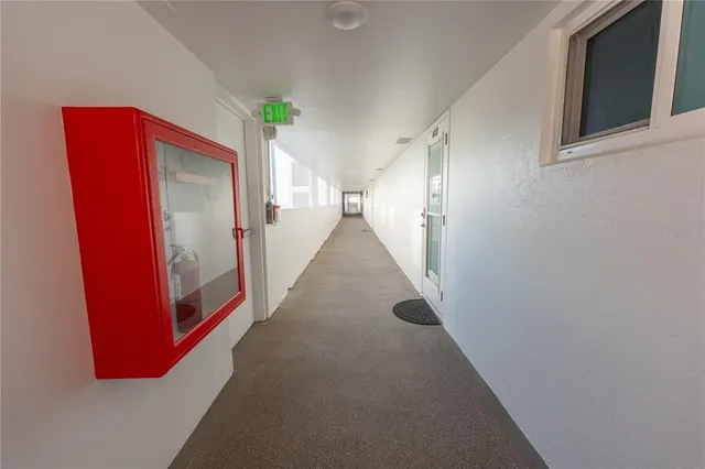 a view of hallway with window and cabinet