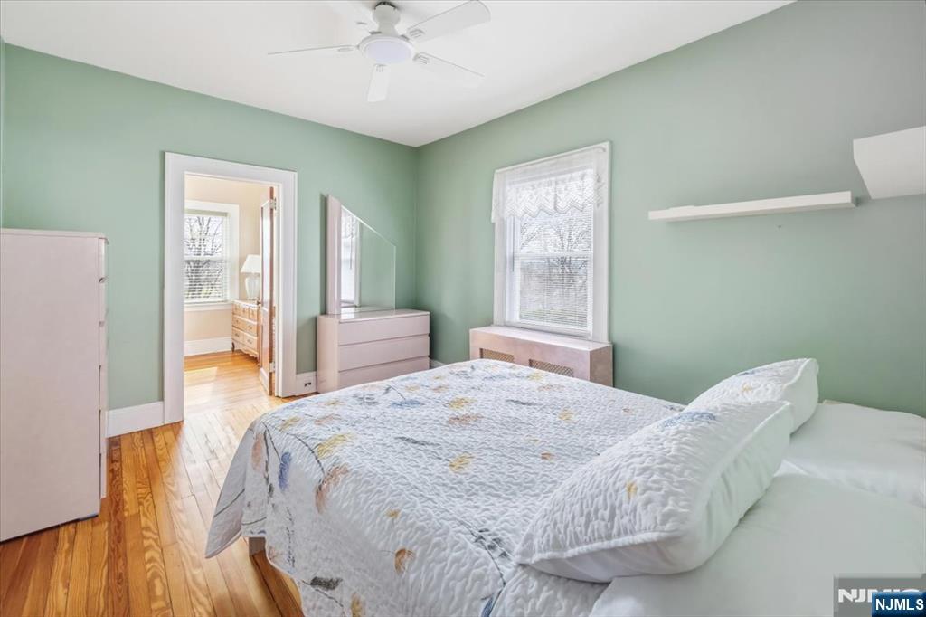 119 Overpeck Avenue Ridgefield Park, NJ 07660 - Photo 15 of 44 a bedroom with a bed and a chandelier