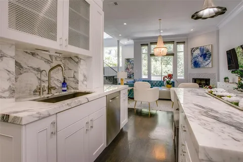 a large white kitchen with a large window