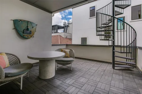 a living room with furniture and a painting on the wall